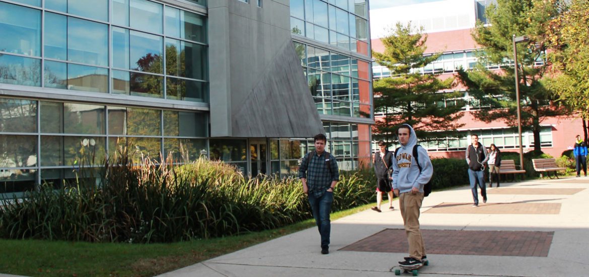 Students rush to classes on Monday morning passing Savitz Hall