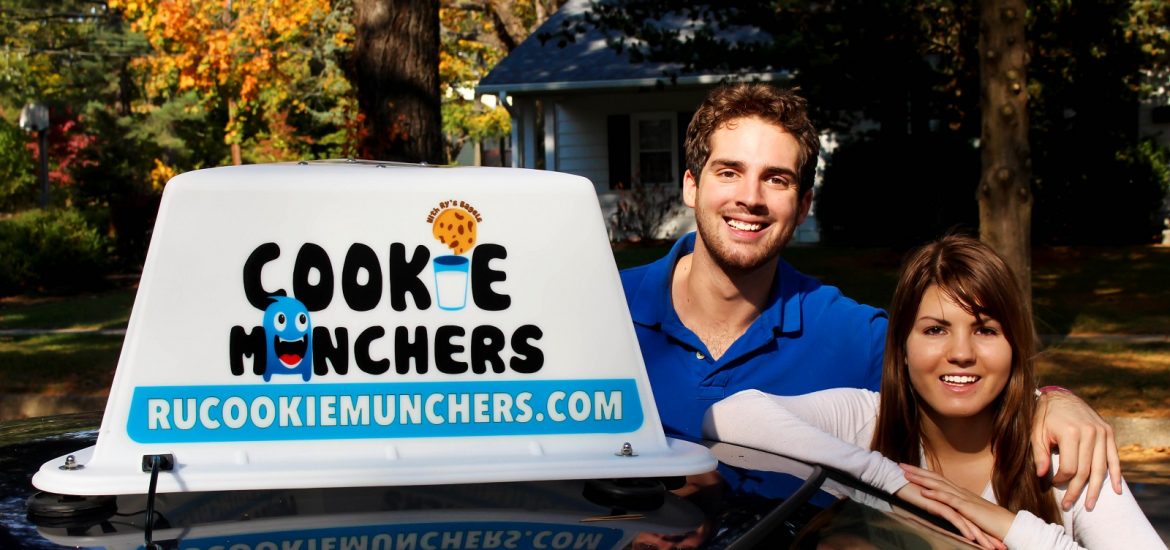 Cassie Aran and Brandon Lucante pose with their new car sign for "Cookie Munchers"