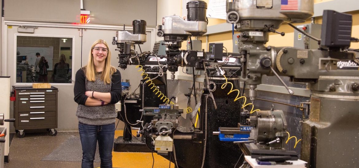 biomedical engineering major Haley stands in a workshop lab