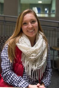 Student poses for portrait in Rowan Hall