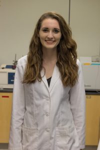 Student in Lab Coat Poses for Portrait