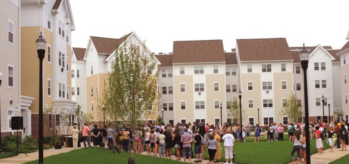 people stand outside of Rowan Boulevard Apartments