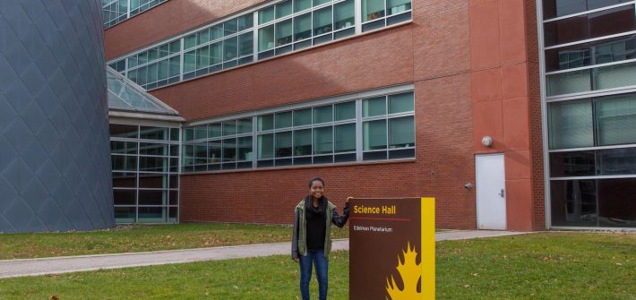 student poses at science center