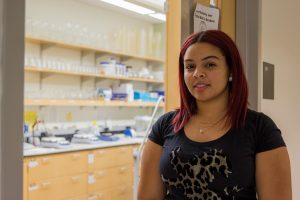 student stands in front of lab