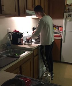 a student cooks in his RoBo apartment