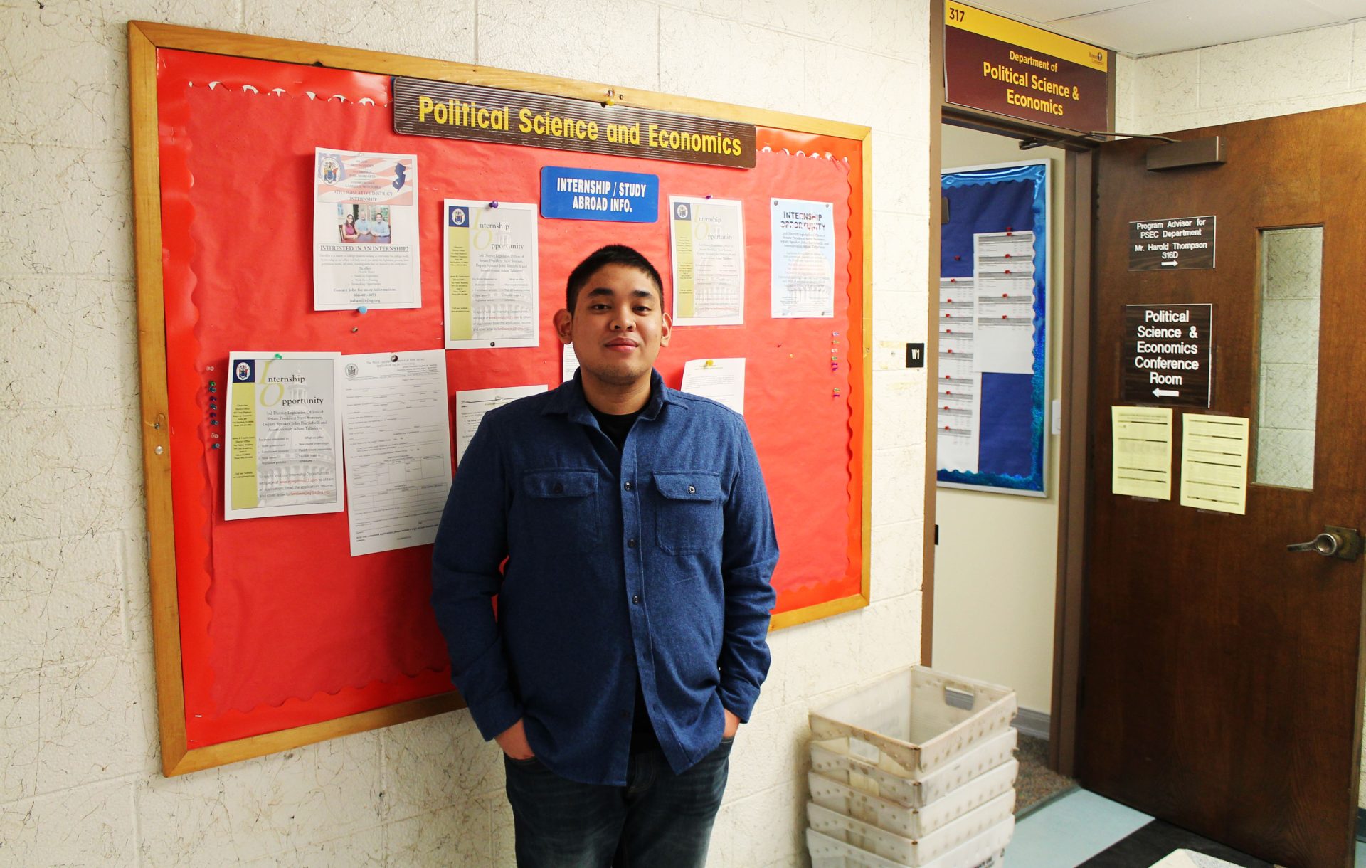Political Science Major Andrew Bautista in front of Political Science and Economics department