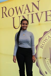 Tsion Abay International Student from Ethiopia is in front of Rowan University sign