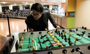 Rowan RTF Student Frank Villarreal spends time playing table hockey at the Student Center