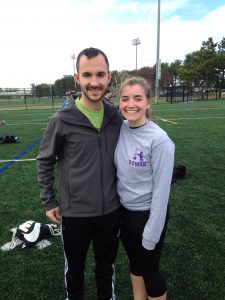 annie and vincent, two students poses outside on fields