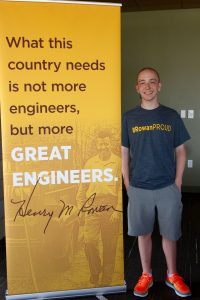 standing next to engineering poster