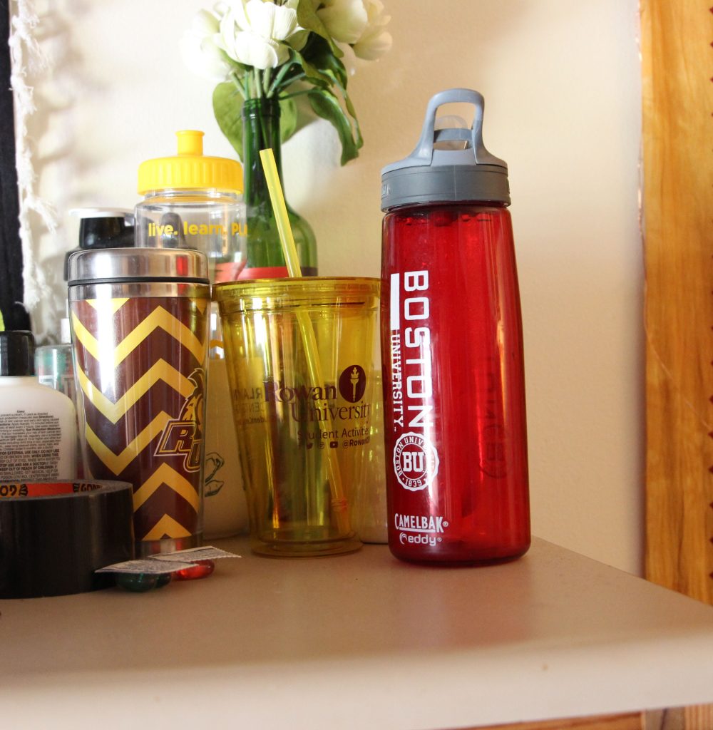 A Boston University water bottle next to three Rowan bottles on Kaylin's dresser.