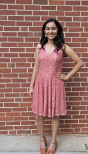 girl standing in front of brick