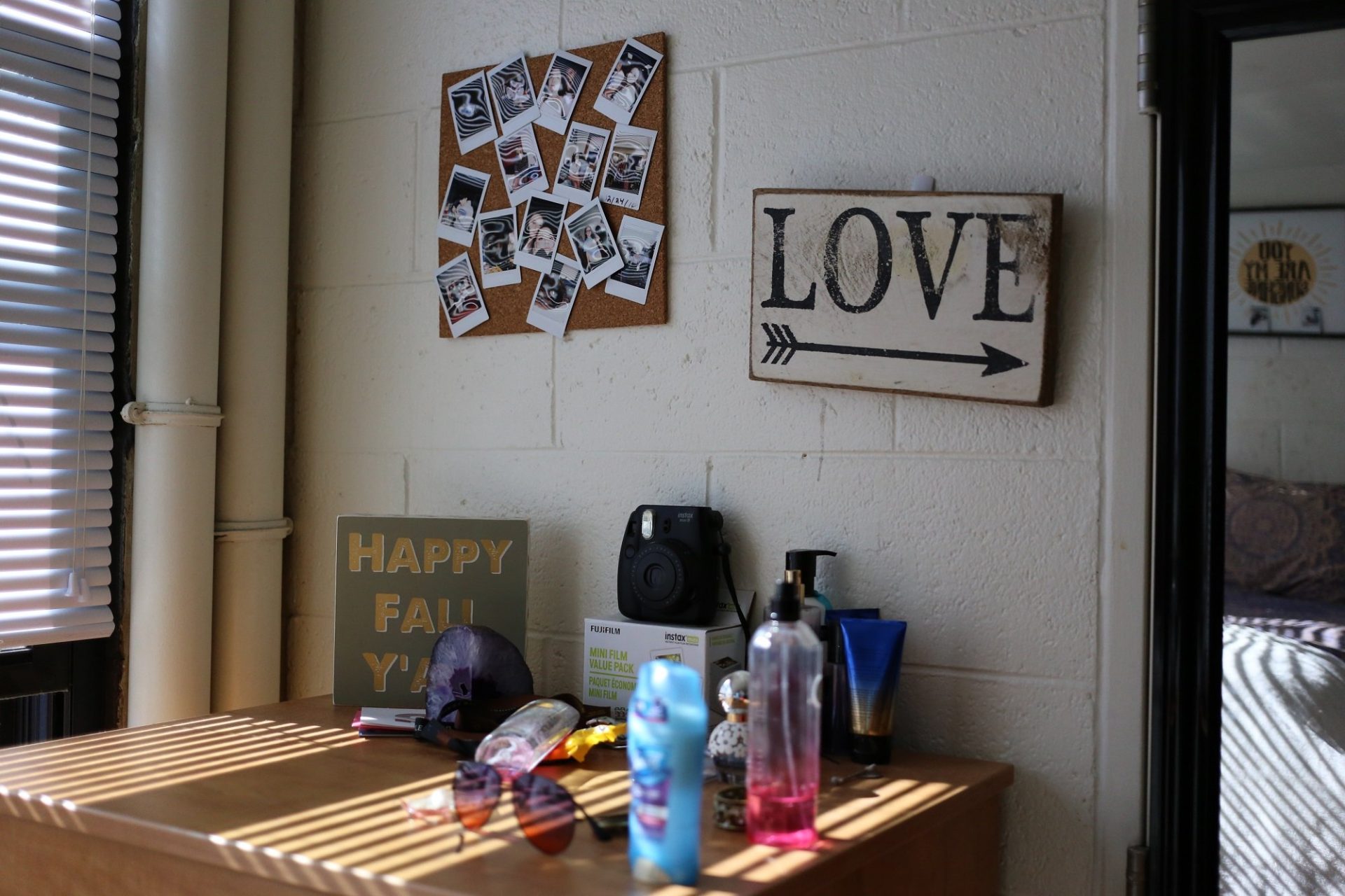 A photo of a bulletin board and printed sign on the dorm room wall of a student