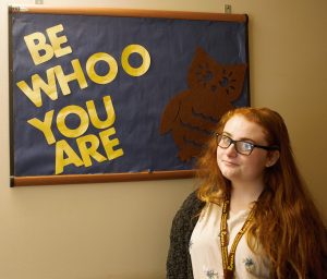 Sophomore Laura Colandrea shows off one of the many bulletin boards she has made to decorate Chestnut Hall, where she is an RA.
