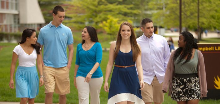 Rowan University students walking outside of Campbell Library