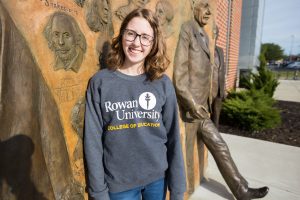 Rowan student Chrissie outside James Hall in College of Education sweatshirt 