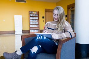 Nicole writing in the library.