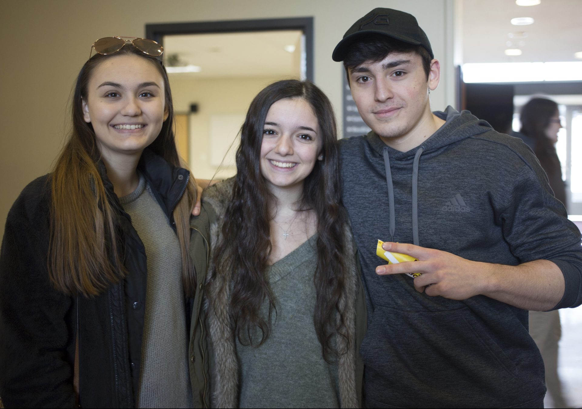 Three prospective Education students stand in James Hall at Rowan University's Accepted Students Day for the College of Education.