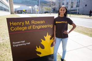 Sidney in her #ROWANproud shirt at the Henry M. Rowan College of Engineering building sign outside