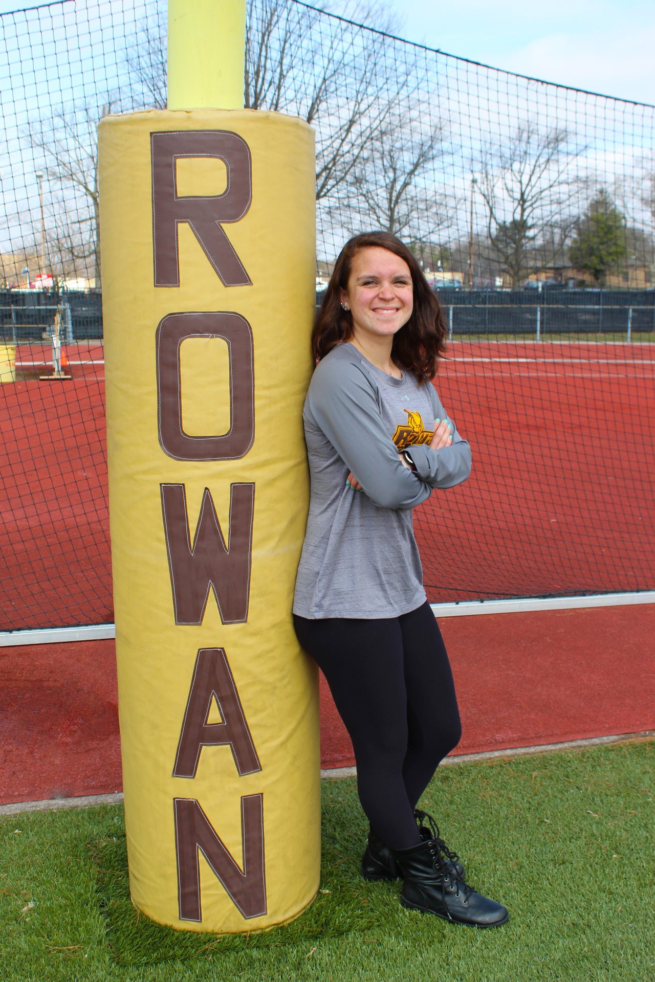 Brianna de la Cruz, a Nutrition and Dietetics major at Rowan University, stands on the track.
