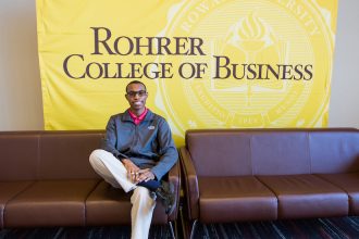 Davon sitting on the couch inside the Rohrer Business of college at Rowan University in Glassboro NJ