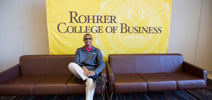 Davon sitting on the couch inside the Rohrer Business of college at Rowan University in Glassboro NJ
