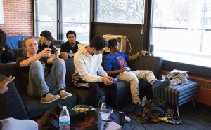 five people sit in Mullica Hall lounge at Rowan University