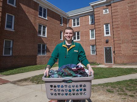 Chesnut Hall resident carries laundry at Rowan University