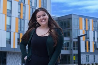 Rowan University Student outside holly pointe commons