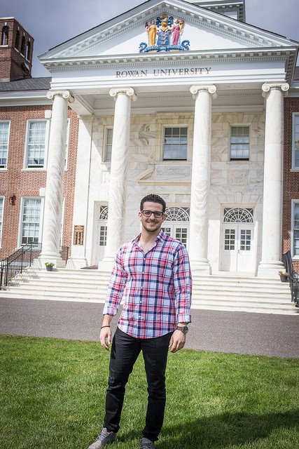 Brandon stands in front of the white columns of Bunce