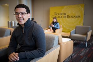 student sits on couch in Rohrer business building