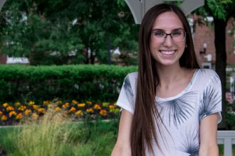 Molly, a transfer student, standing in a gazebo near Bunce.