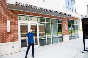 Matt outside the college of communications and creative arts building 