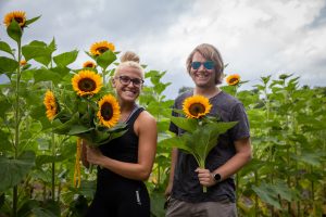 Rowan University students pose with sunflowers they picked at Hill Creek Farms