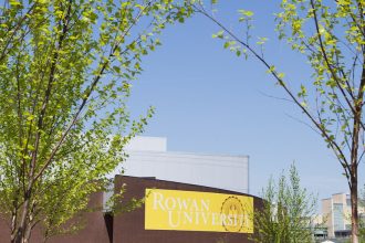 Rowan University Wilson Hall with Rowan Banner in springtime