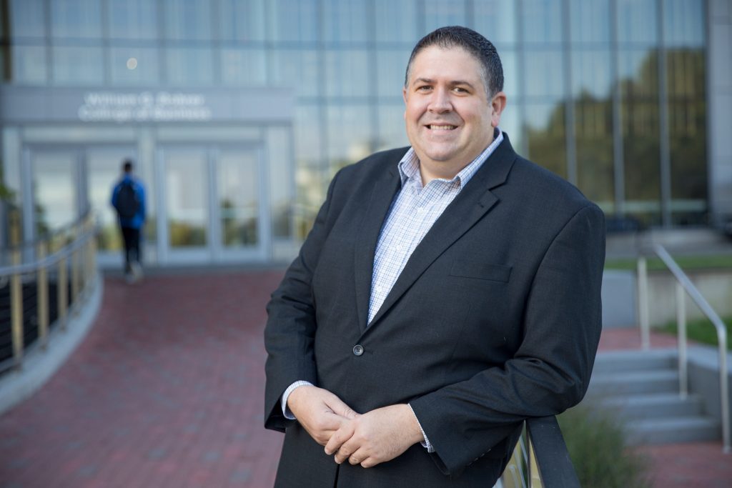 A portrait of Eric Liguori outside the rohrer college of business