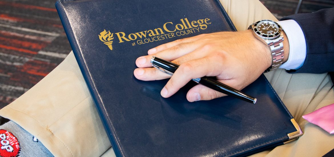 business folder and student at Rowan University