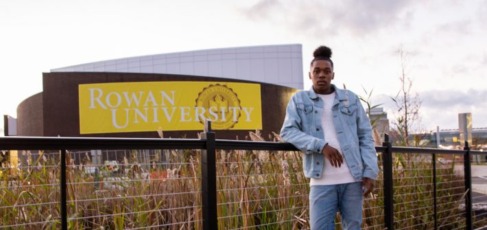 Student outside Wilson Hall on bridge