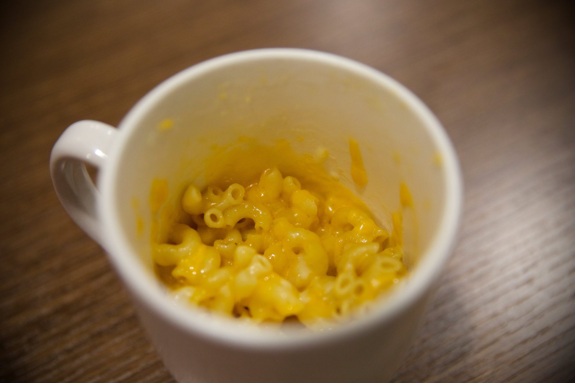 Close up of finished mac & cheese in a white coffee mug.