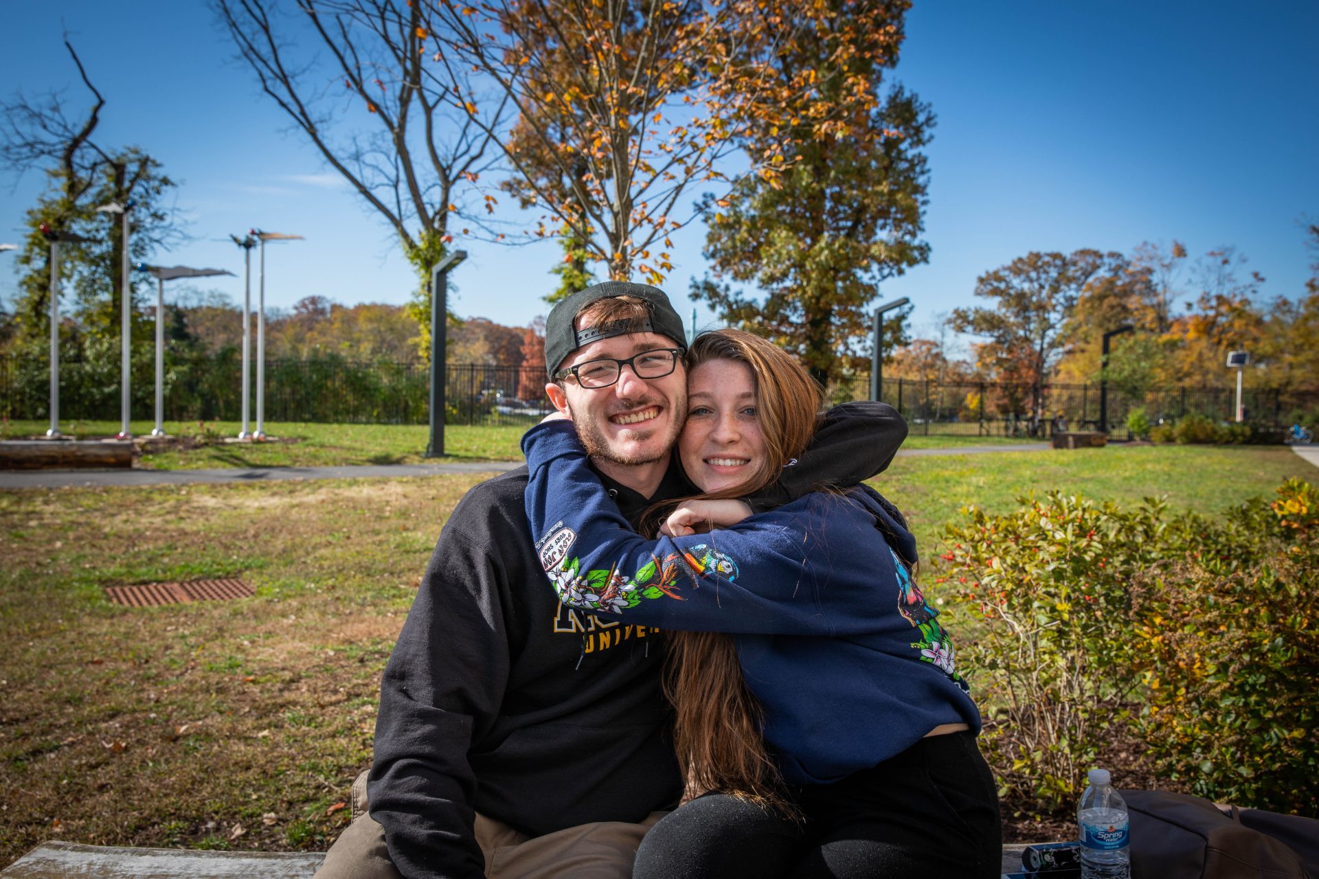 Mike sitting with a friend outside of Holly Pointe Commons.