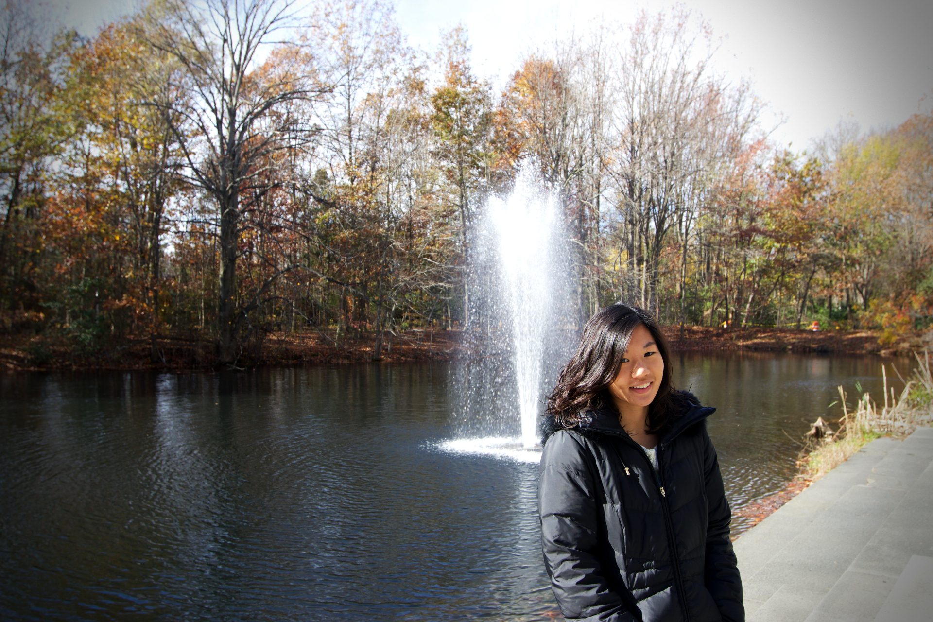 Rowan student, Jean Han, posing in front of the Engineering buildings fountain.