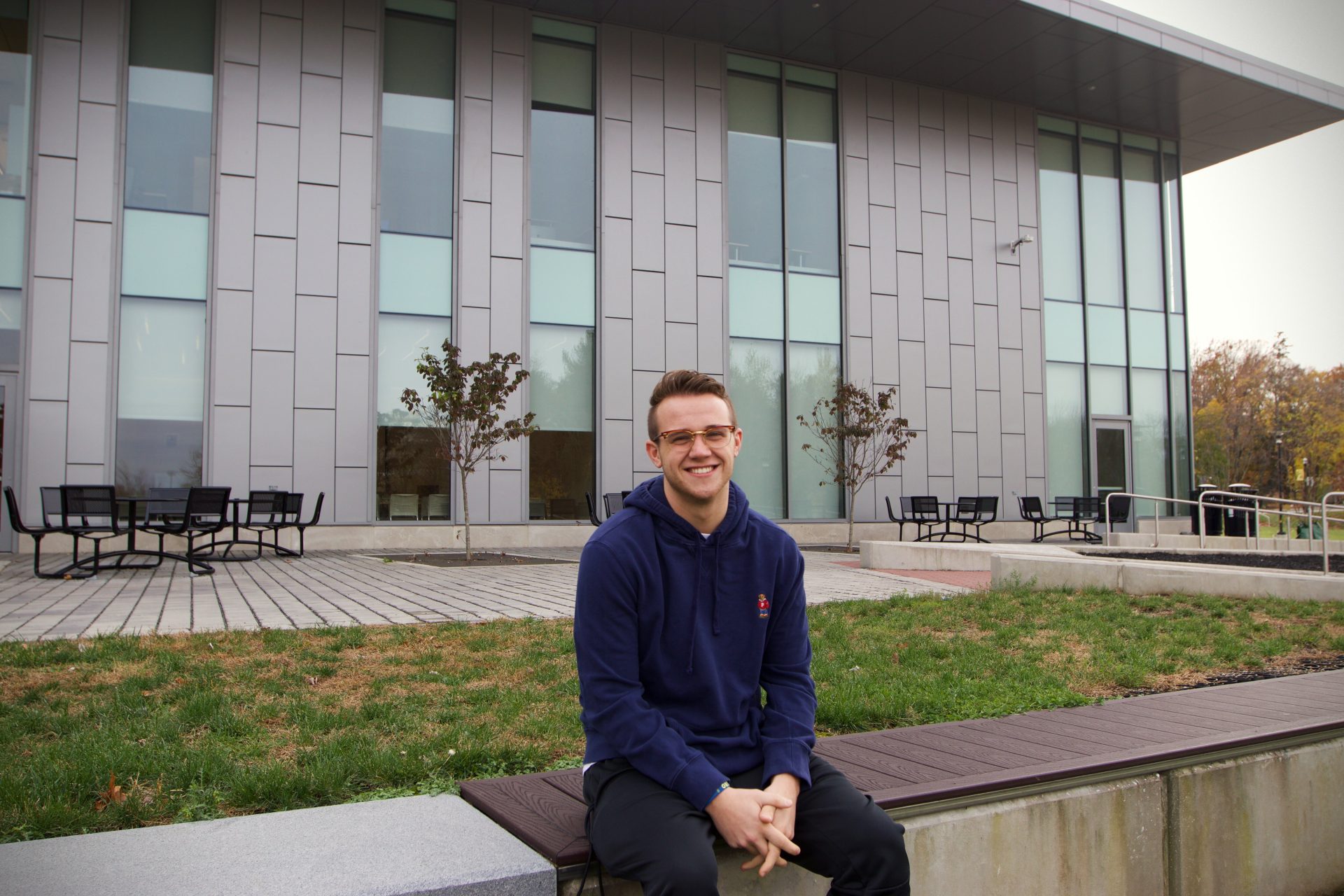 Eric sitting outside of Rowan's William G. Rohrer College of Business.