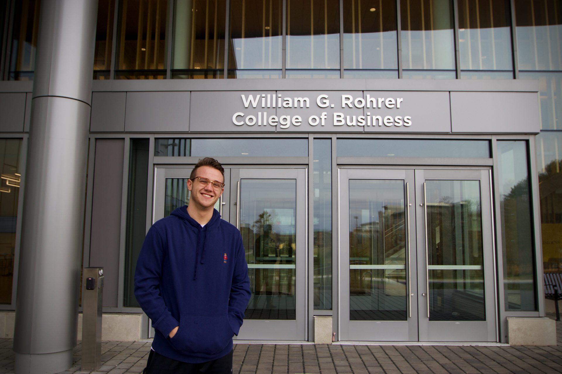 Eric posing in front of Rowan's William G. Rohrer College of Business.