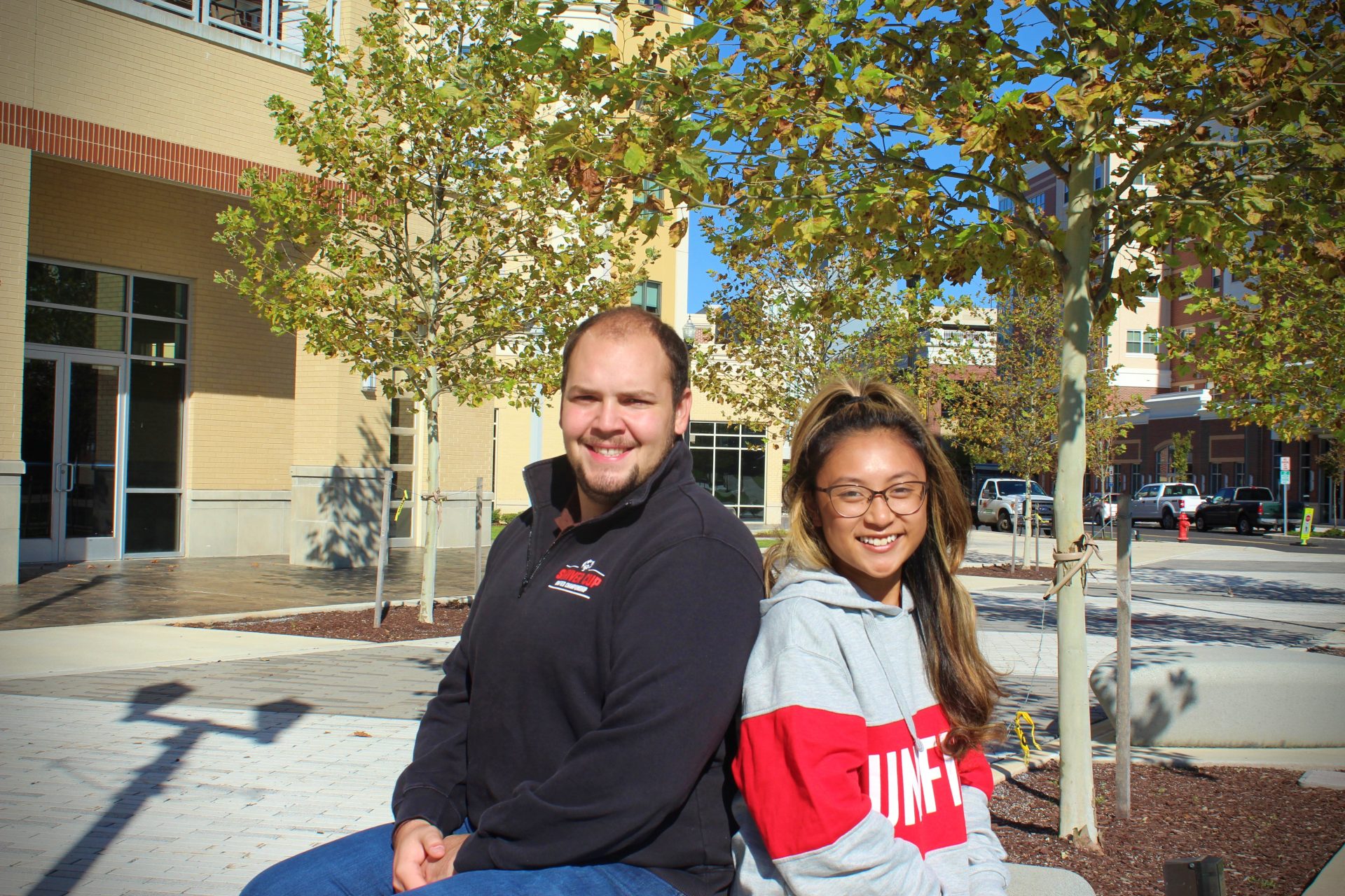 Joe (left) and Kaitlee (right) sitting on a bench at Rowan's campus.