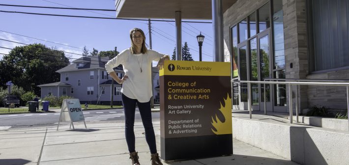 A female student standing outside 301 High Street