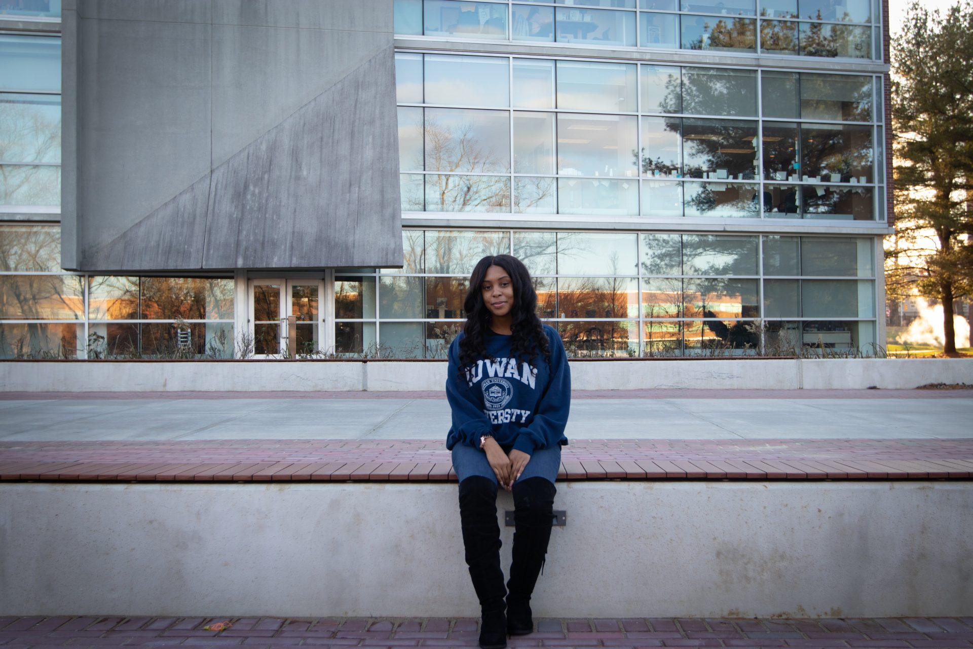 Jasmine sitting in front of Savitz Hall at Rowan University.