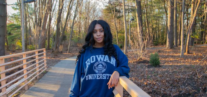 Jasmine Taylor stands behind the business building on the bridge