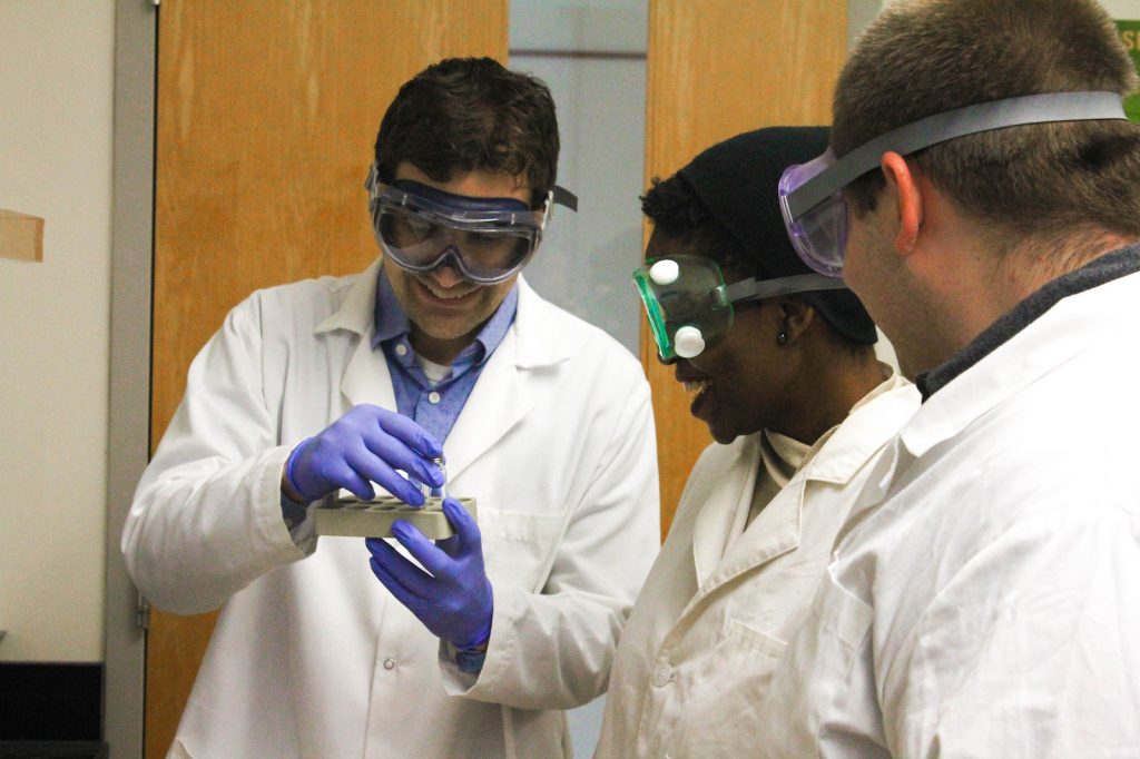 Analytical chemist James Grinias at Rowan University shows a specimen to students