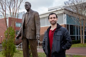 Dave next to Mr. Rowan statue outside Savitz 