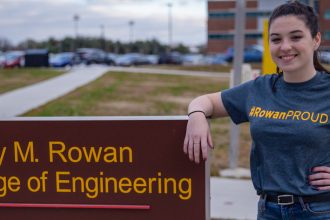 Kelly outside Rowan College of Engineering sign outside